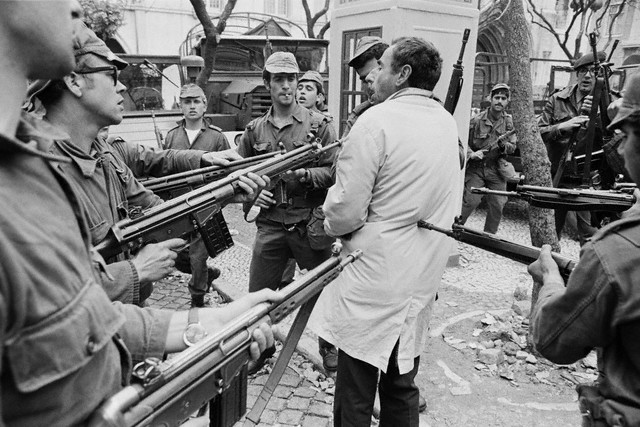 April 1974, Lisbon, Portugal --- A suspected member of PIDE, the secret police, being arrested by soldiers during the Carnation Revolution. --- Image by © Henri Bureau/Sygma/Corbis