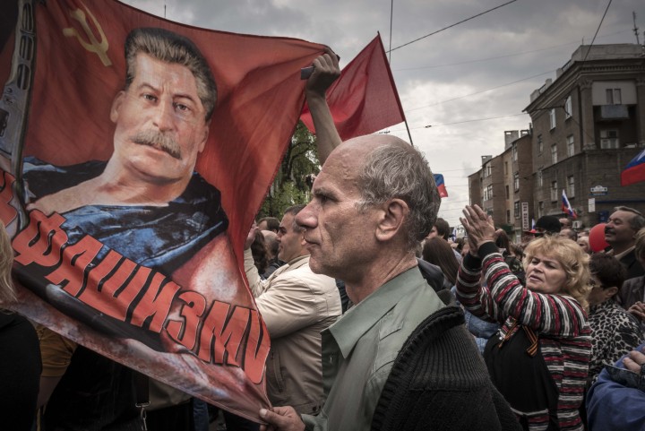 People with soviet flags and a portrait of Josef Stalin attend the May demonstration in Donetsk, Ukraine, Thursday May 1, 2014. (Photo Sergey Ponomarev for The New York Times)