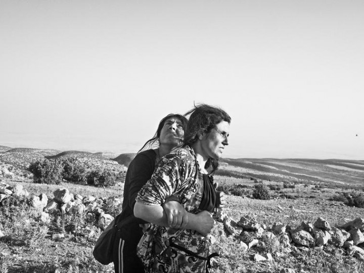 IRAQ. Sinjar Mountains. August 12, 2014. Yazidi women stranded in the Singar Mountains wait for the arrival of a rescue helicopter. Discordia-Moises-Saman