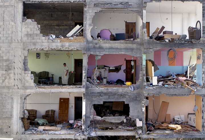 Palestinian man Mousa Sweidan,50, walks in one of the rooms of his father's damaged home in the Sha'af neighborhood of Gaza City , August 15,2014 . A cease fire between Israel and the Hamas -controlled Gaza Strip enabled him to travel back to the damaged home , the family of 15 had earlier fled for safety when Israeli tanks entered the neighborhood. The Sha'af neighborhood of Gaza City was heavily damaged during the 50 day war between Israel and the Hamas-controlled Gaza Strip as Israeli troops reduced many of the homes to rubble as they searched for underground tunnels that reached to the border of Israel . The war destroyed lives, homes, left thousands displaced and weary that a peaceful solution will or could ever be implemented anytime soon as so many on both sides fear , this will only happen again .(Photo by Heidi Levine /Sipa Press).